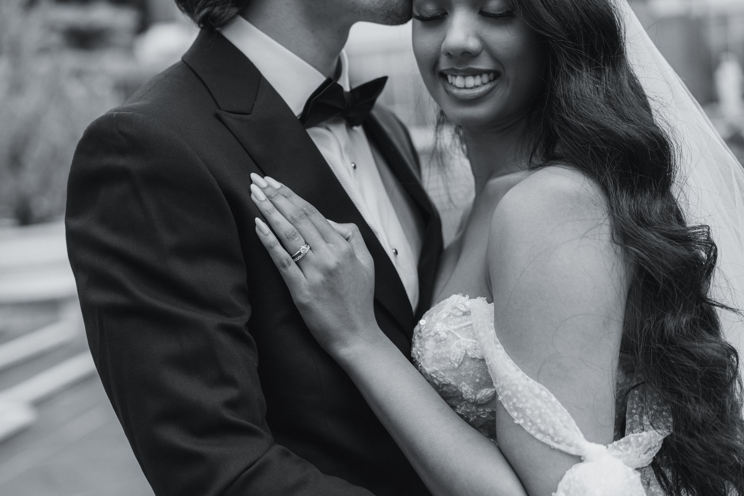 Intimate black and white portrait of newlyweds sharing tender moment.