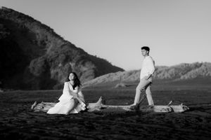 A series of black and white romantic photos showing a couple sitting together against a dramatic mountain landscape.