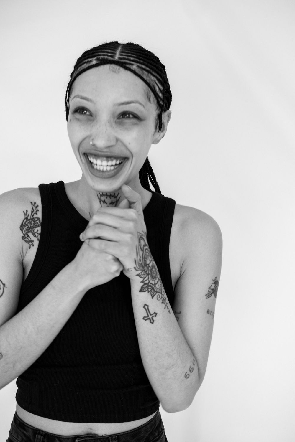Black and white portrait capturing genuine laughter and expressive pose.