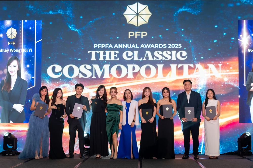 Group photo at an awards ceremony with PFP Classic Cosmopolitan branding and blue stage lighting.