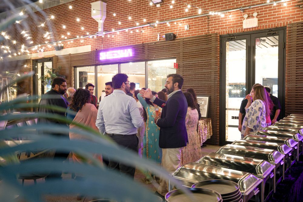 Modern brick-walled venue space with ambient lighting and guest seating.