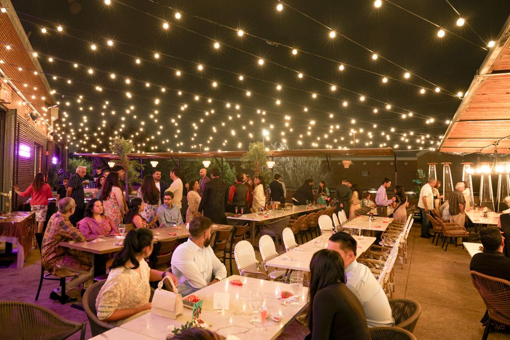 Outdoor evening venue decorated with romantic string lights creating a magical ambiance.
