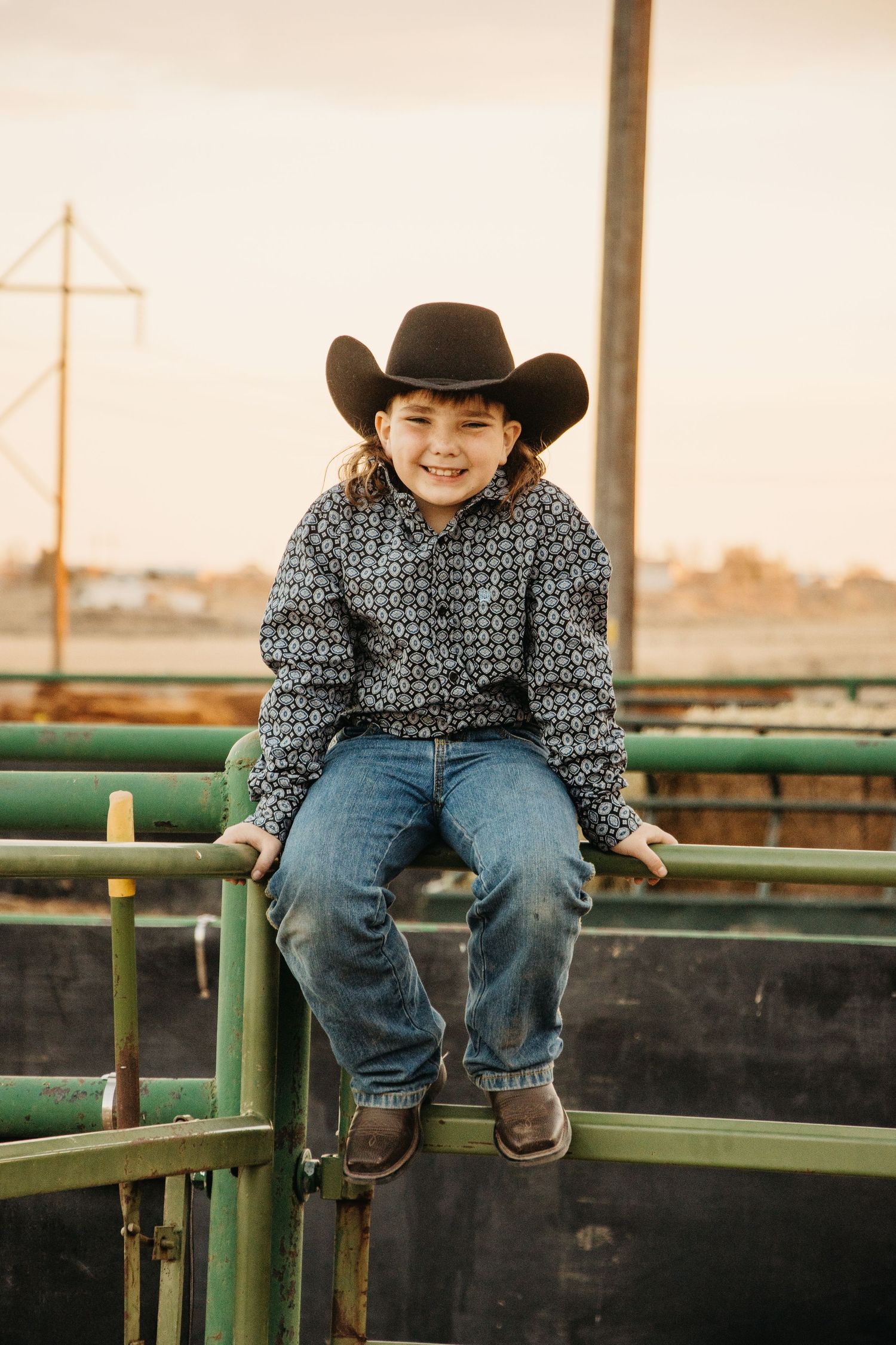 Cowboy grit during this baptism portrait session as he changed from his suit to his natural attire to smile in front of the cows on the farm