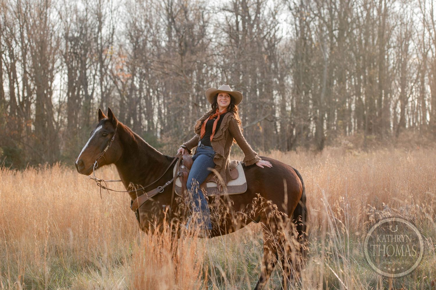 Western equestrian riding through a serene field of golden grass during golden hour.