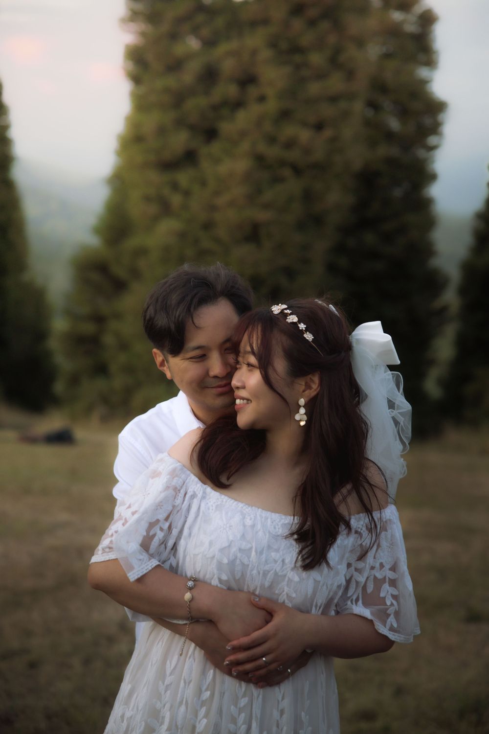 A tender moment captured between a couple during their mountain wedding photoshoot at sunset.