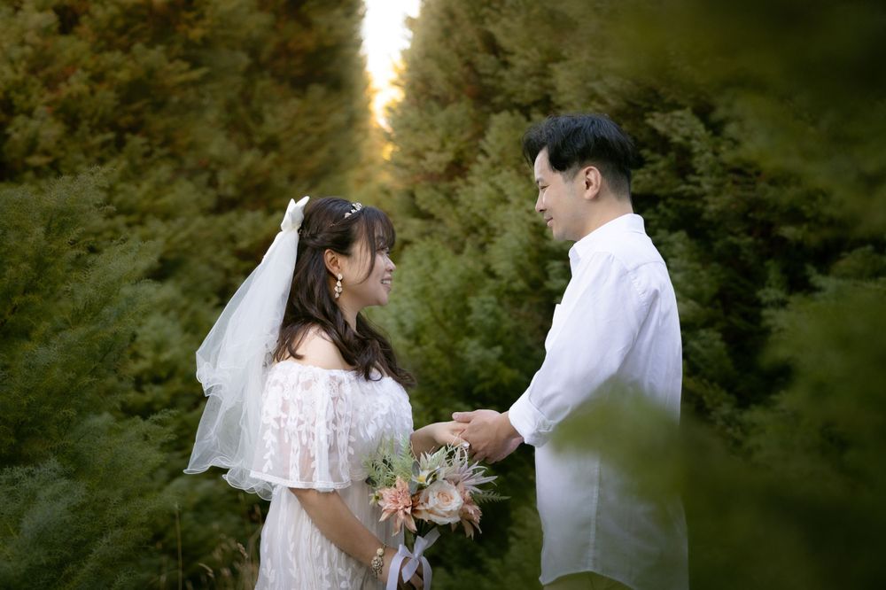 A romantic mountain wedding photoshoot with evergreen trees and soft natural lighting.