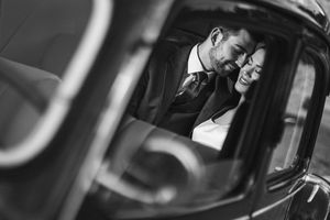 Black and white romantic moment captured through a vintage car window. Next day wedding photography.