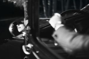 Artistic black and white photo showing blurred motion through car window. Next day wedding photography.
