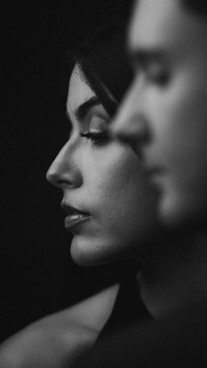 Dramatic black and white profile portrait showing two faces in shadow.