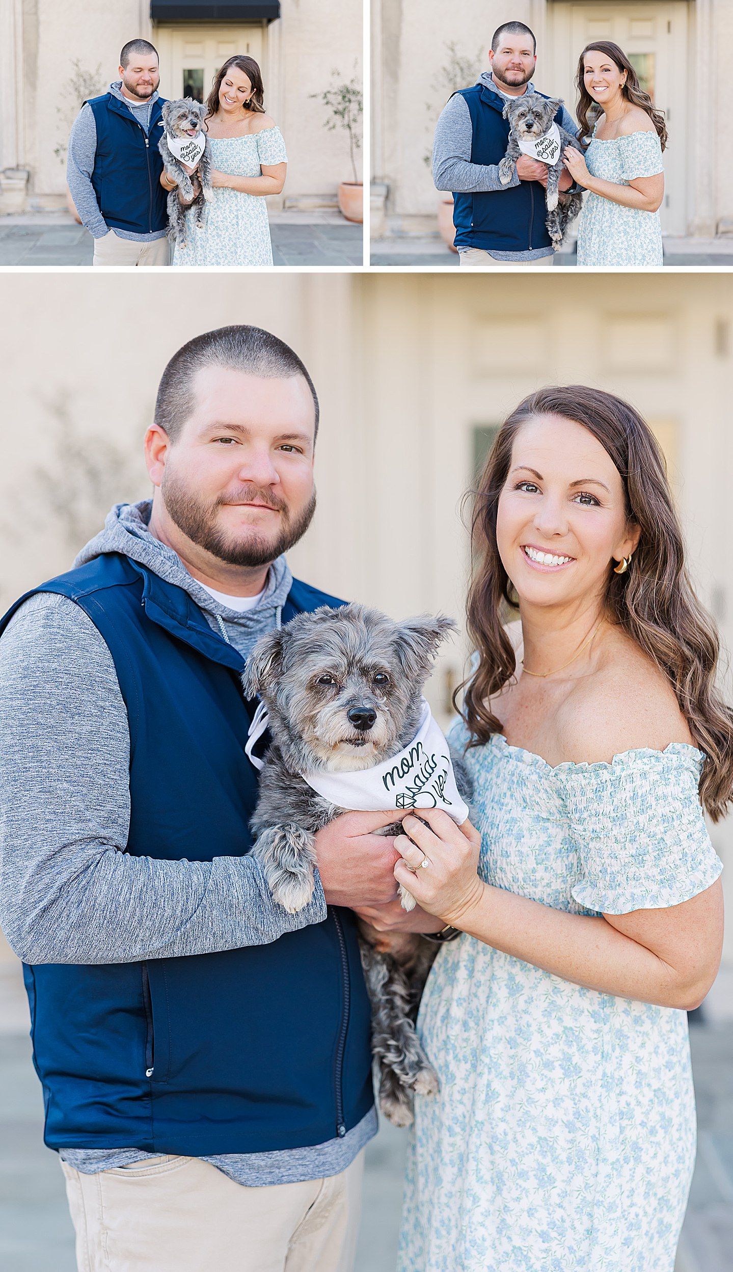 A couple in casual dress poses for photos against a beige wall with their scruffy gray dog wearing a bandana.