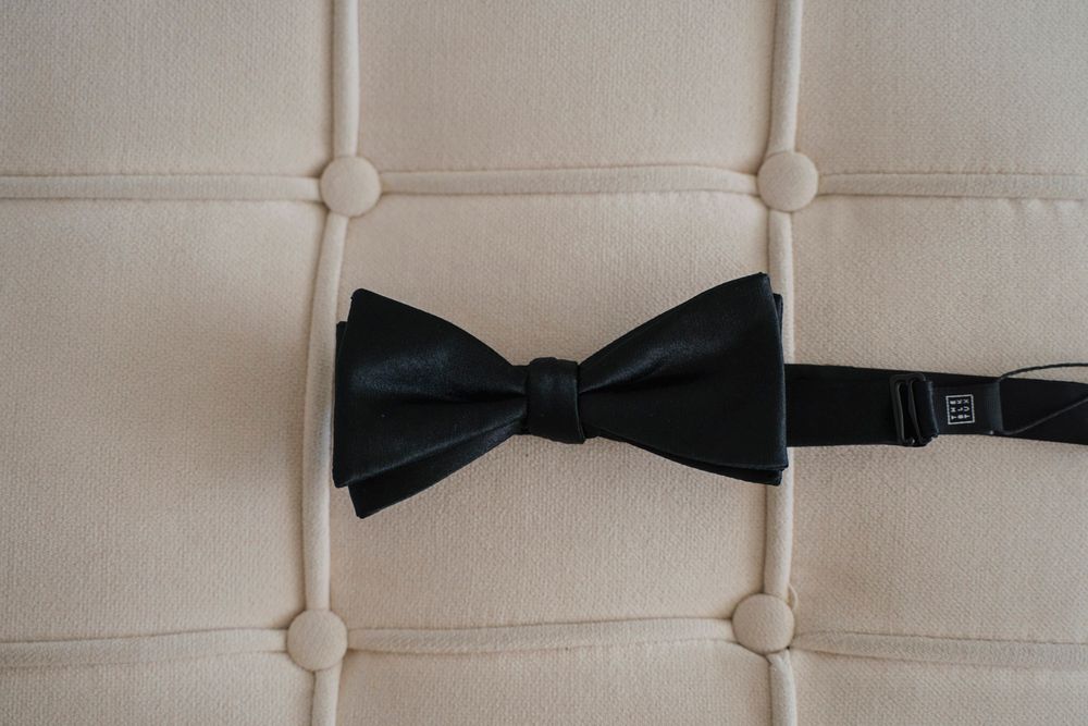 Close-up detail of a classic black bow tie.
