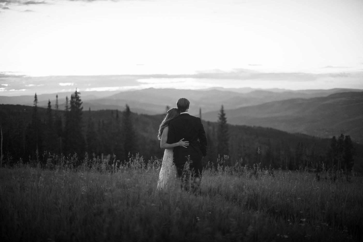 Black and white panoramic wedding photos showing silhouettes against a mountain landscape.