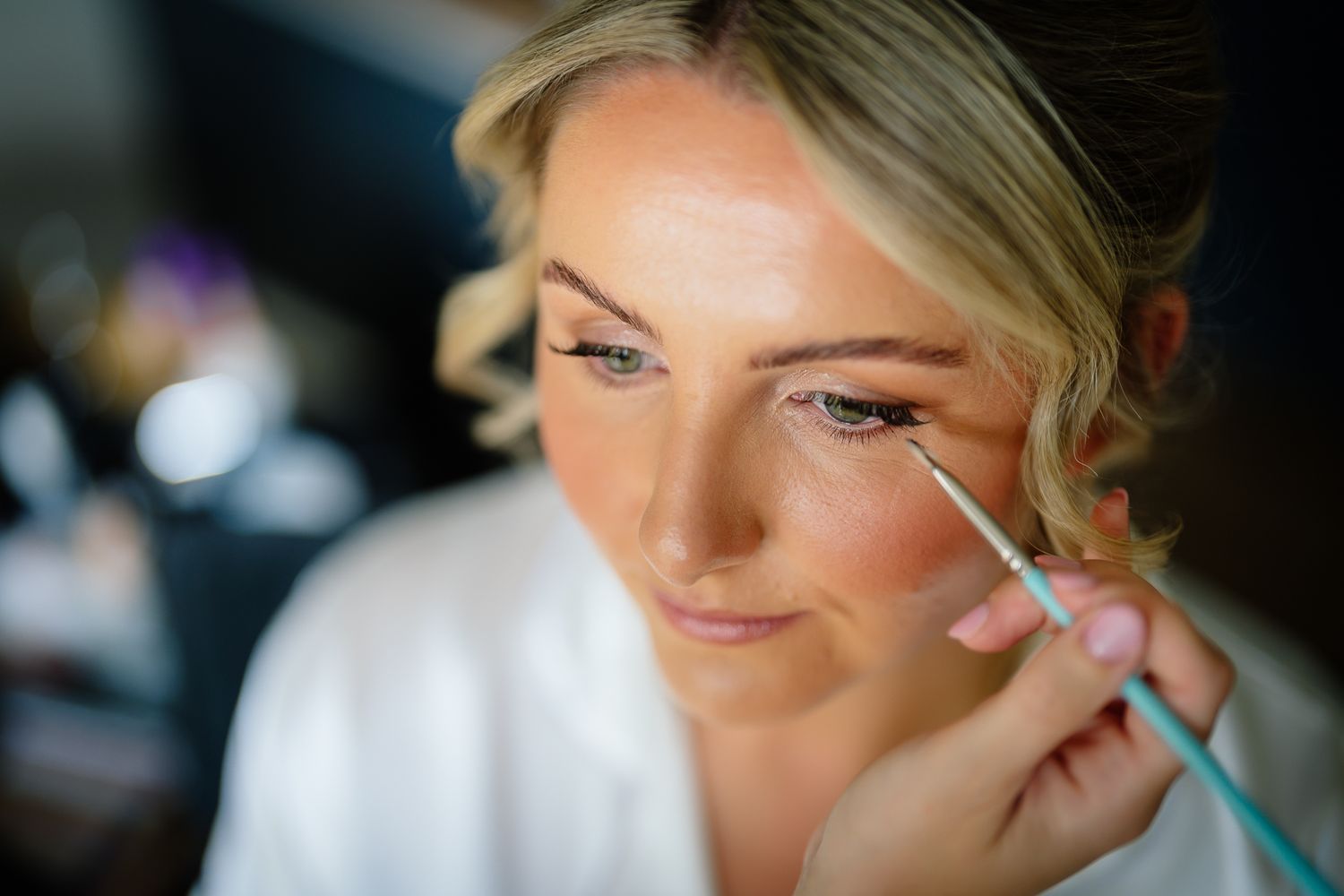 Close-up shots showing makeup application and beauty preparation for a wedding day.