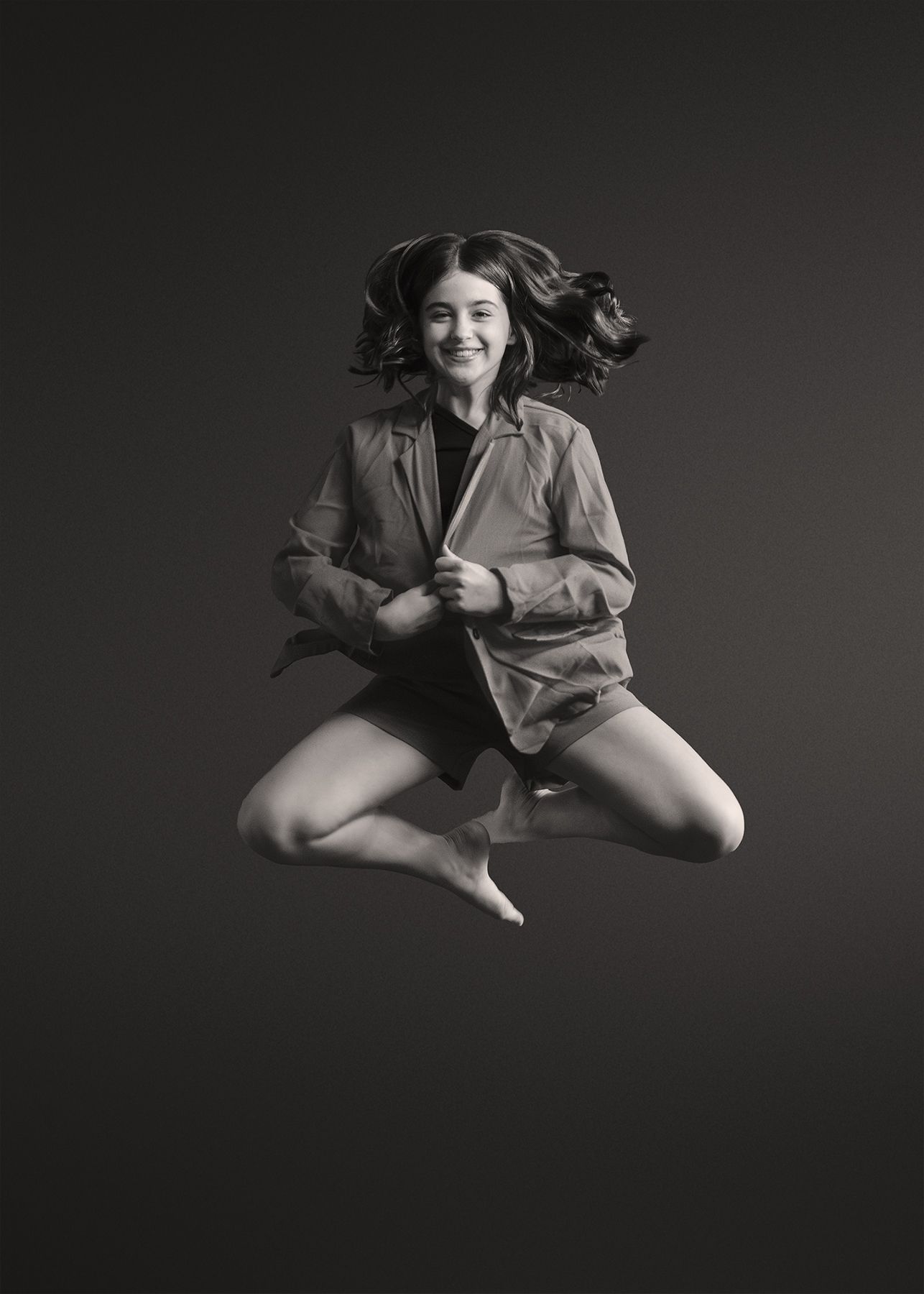 Black and white artistic photo series showing a figure in motion wearing loose clothing against a dark background.