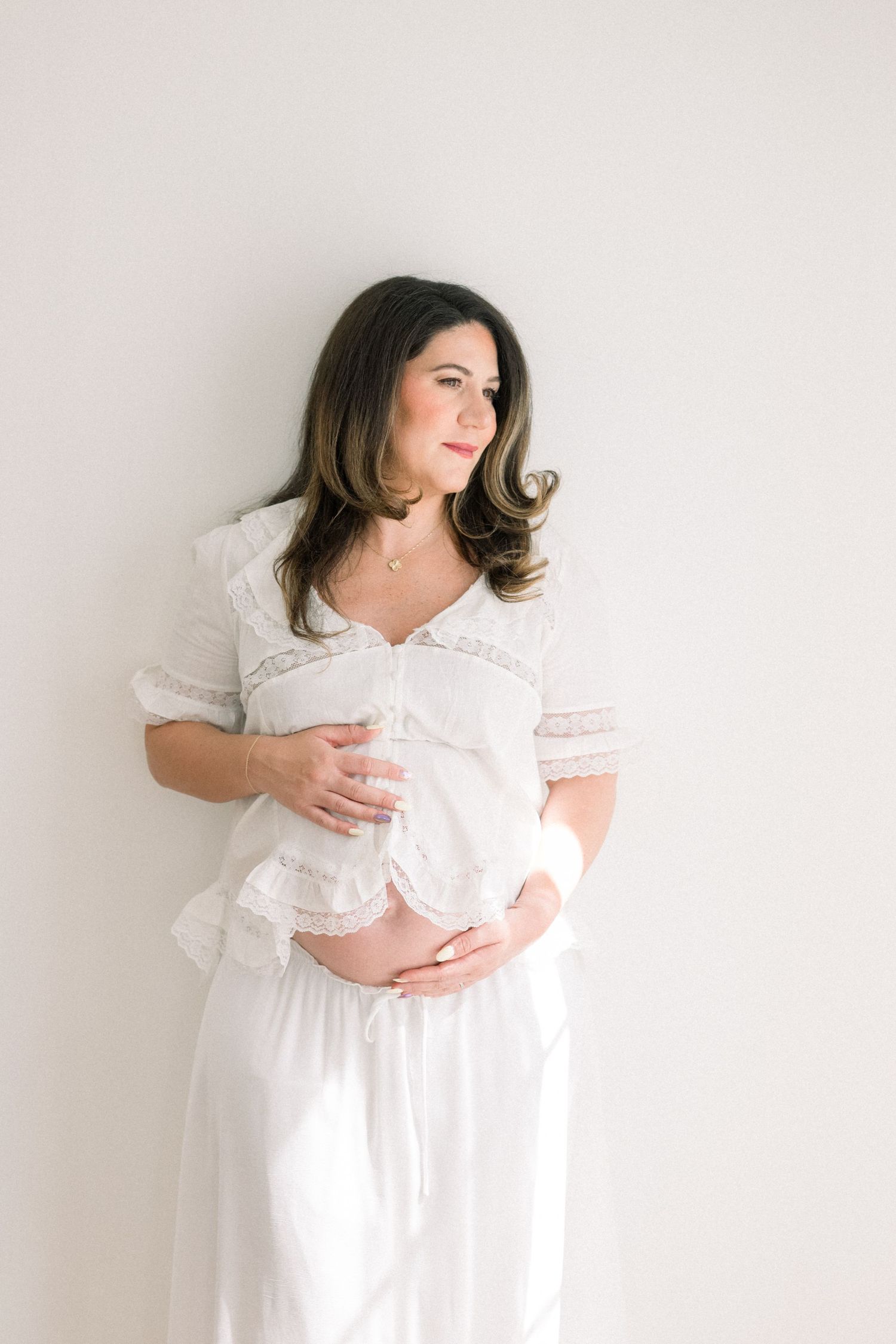 Parents kissing their newborn during an in home newborn session in McLean Virginia