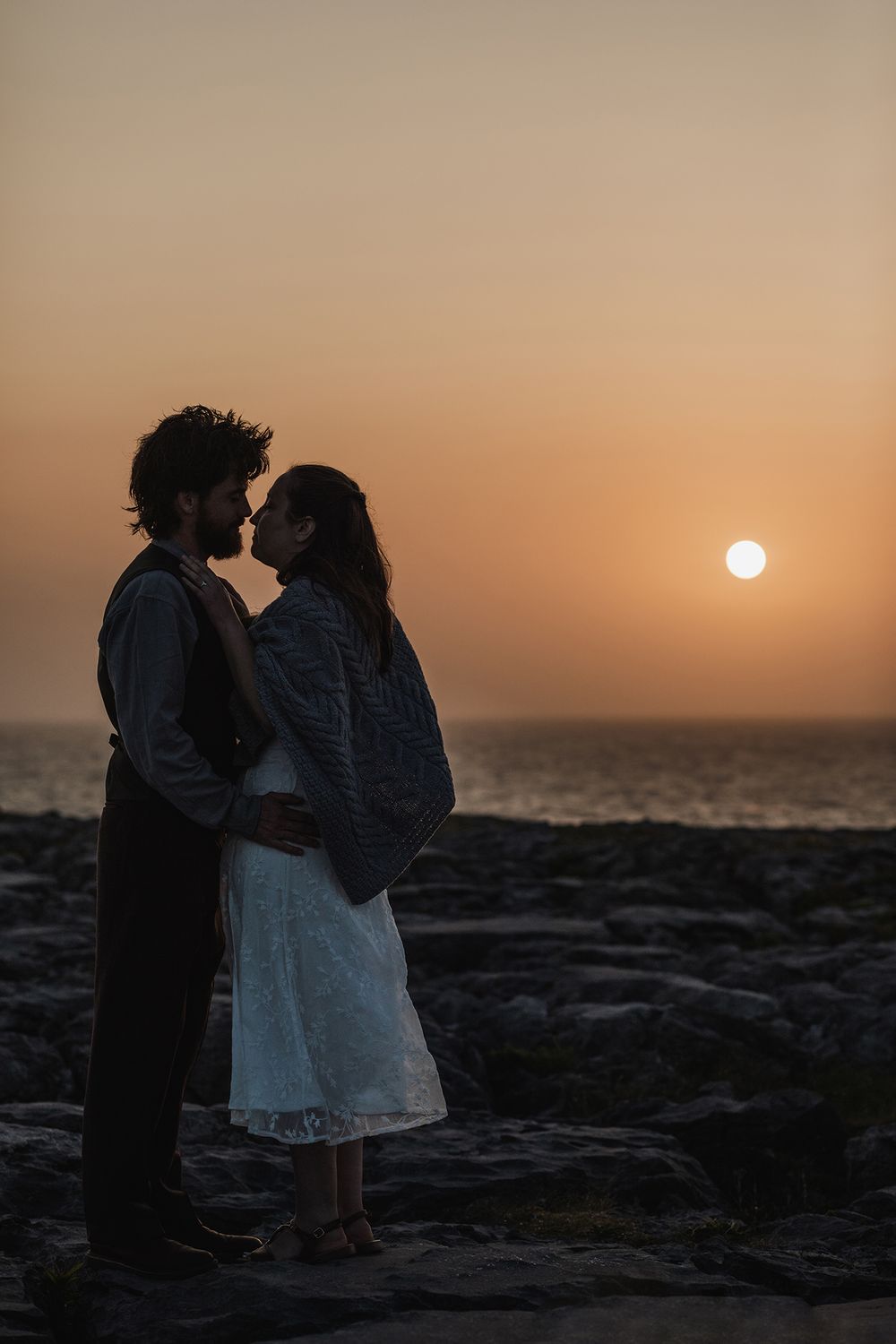 Couple ending their elopement day with sunset portraits along the Burren coastline in County Clare