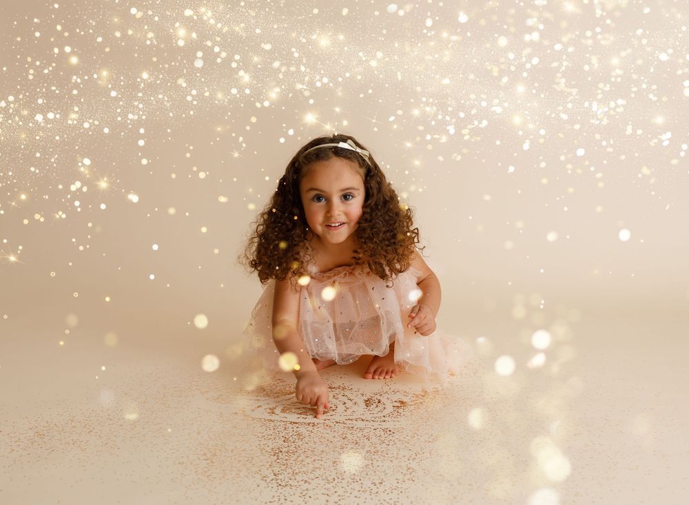 Magical glitter photo session backdrop with sparkling bokeh effects on beige background.