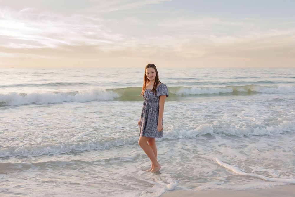 Beautiful beachside photography session with waves crashing on shore during golden hour.