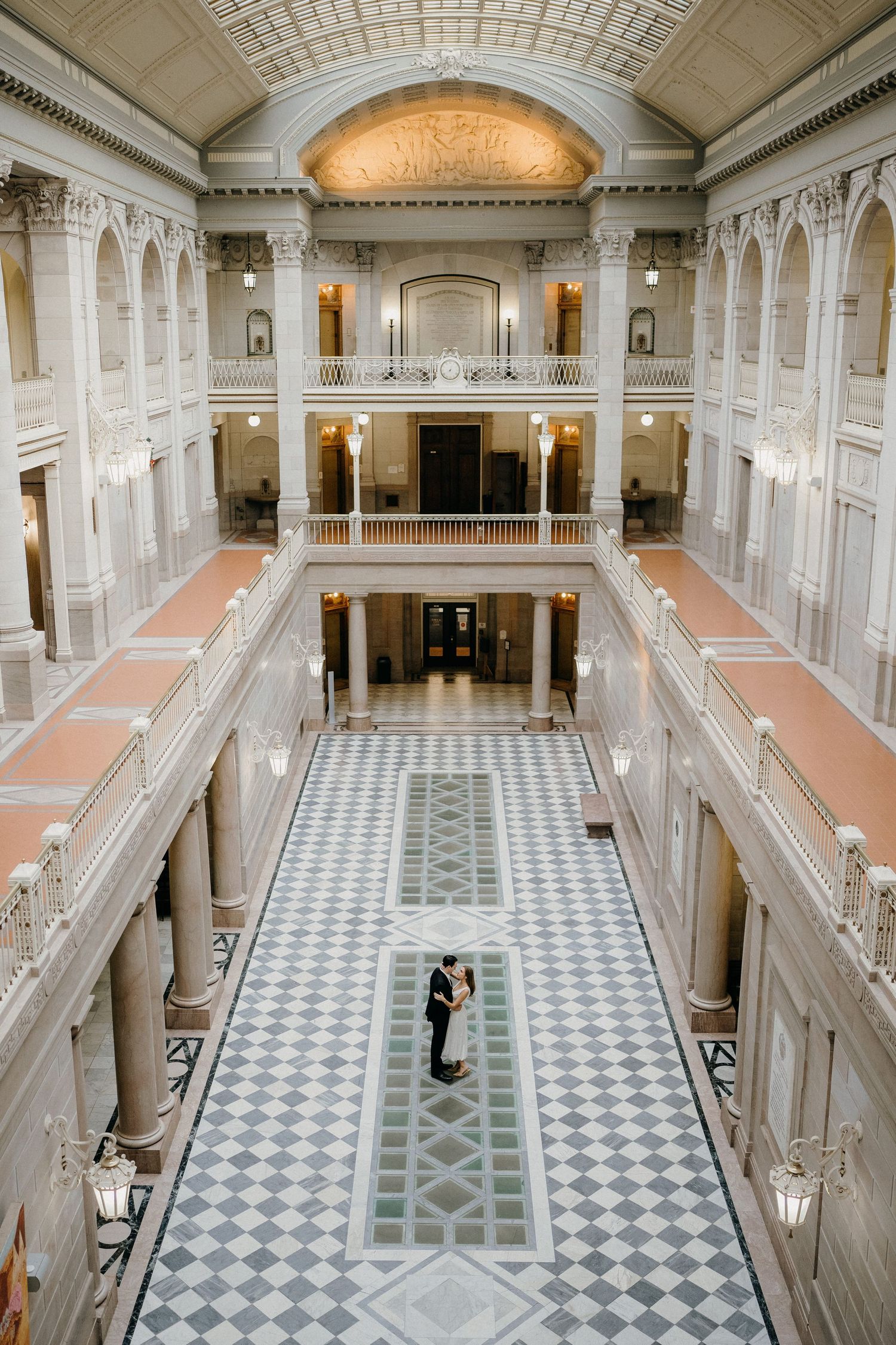 Elegant marble hallway with white columns and checkered floor pattern shown from three different angles in historic building.