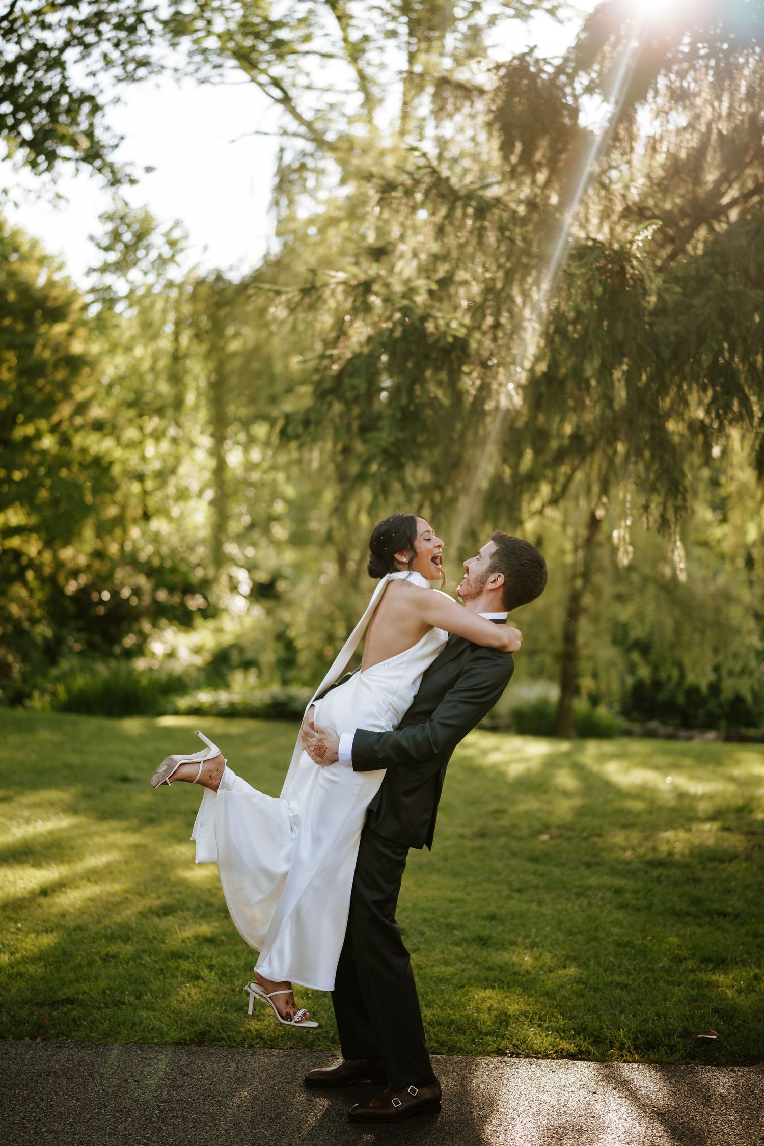 A romantic couple’s portrait on lush green grass at Appleford Estate —perfect lighting, elegance, and emotion in every frame.