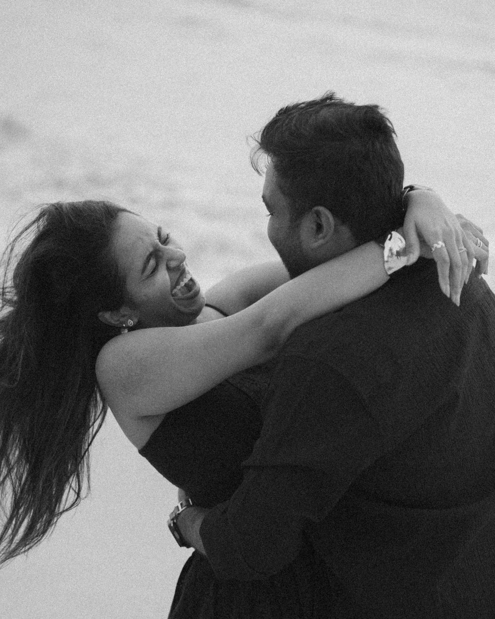 A series of intimate black and white photos showing a couple embracing and sharing tender moments together.