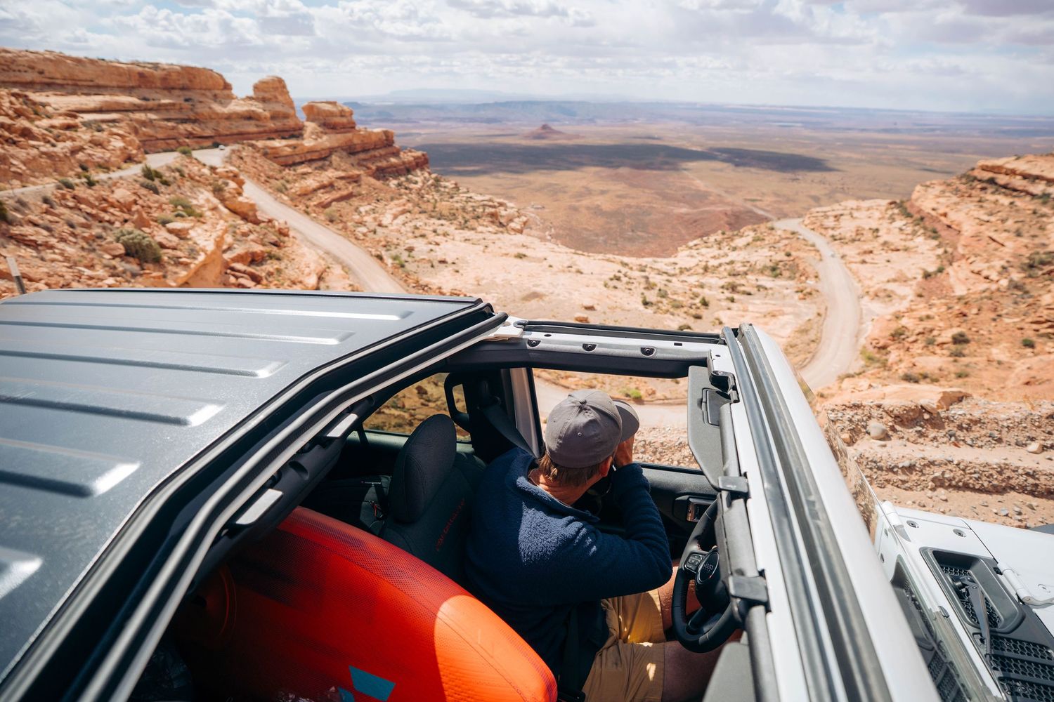 A sequence of photos showing a person taking photographs from a car window in a desert landscape setting.