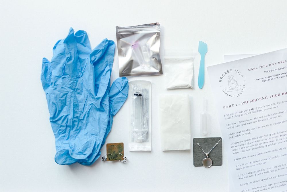 Medical supplies and blue latex gloves arranged on a white surface.