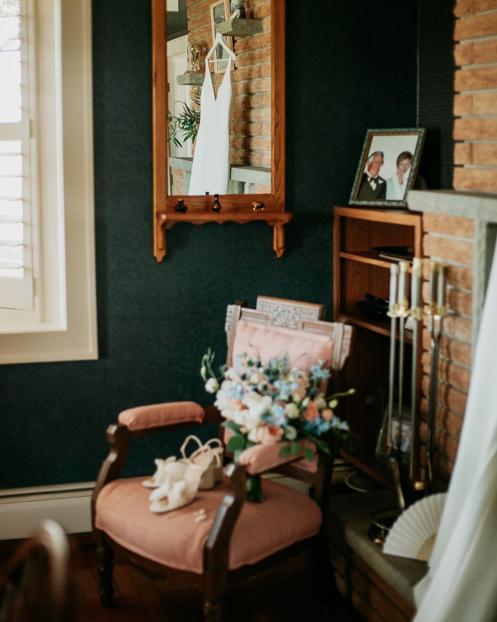 Vintage corner setup with antique chair, mirror, and wedding dress display.