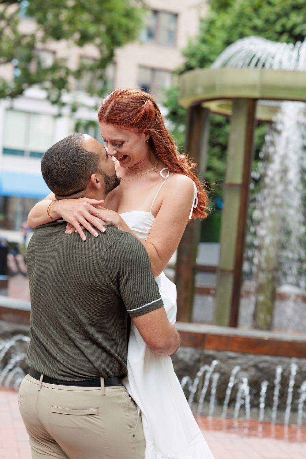 A couple dances romantically near a fountain in a series of connected photos showing their fluid movement.