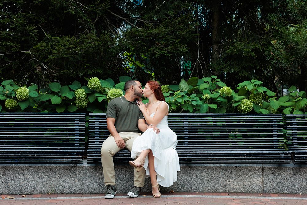 A romantic wedding photoshoot sequence with the couple sitting on a stone wall surrounded by greenery.