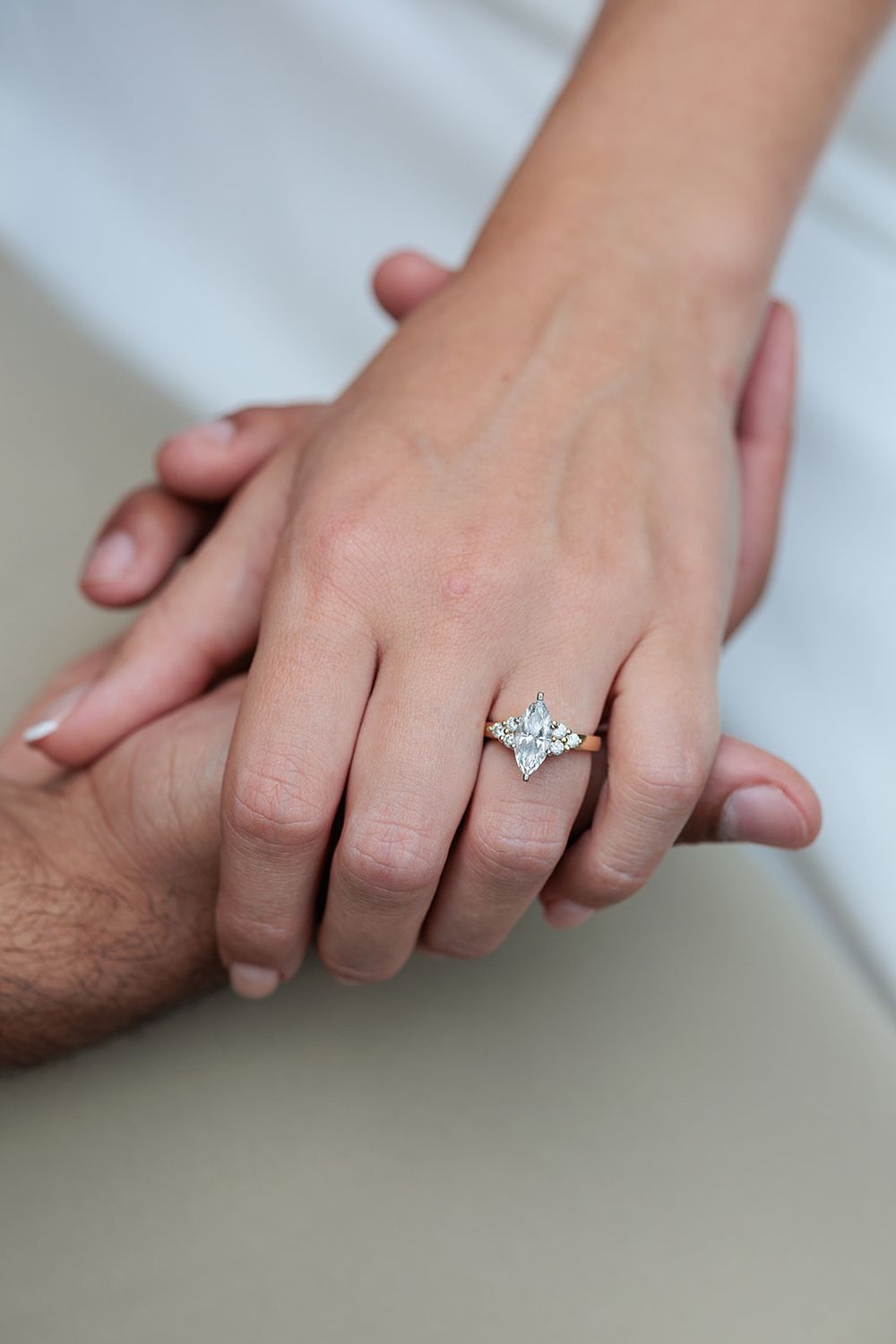 A series of hands holding each other showing engagement rings and wedding bands in a romantic progression.