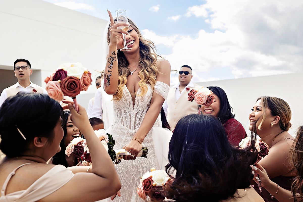 Bride celebrating with her bridesmaids during vibrant Riviera Maya destination wedding.