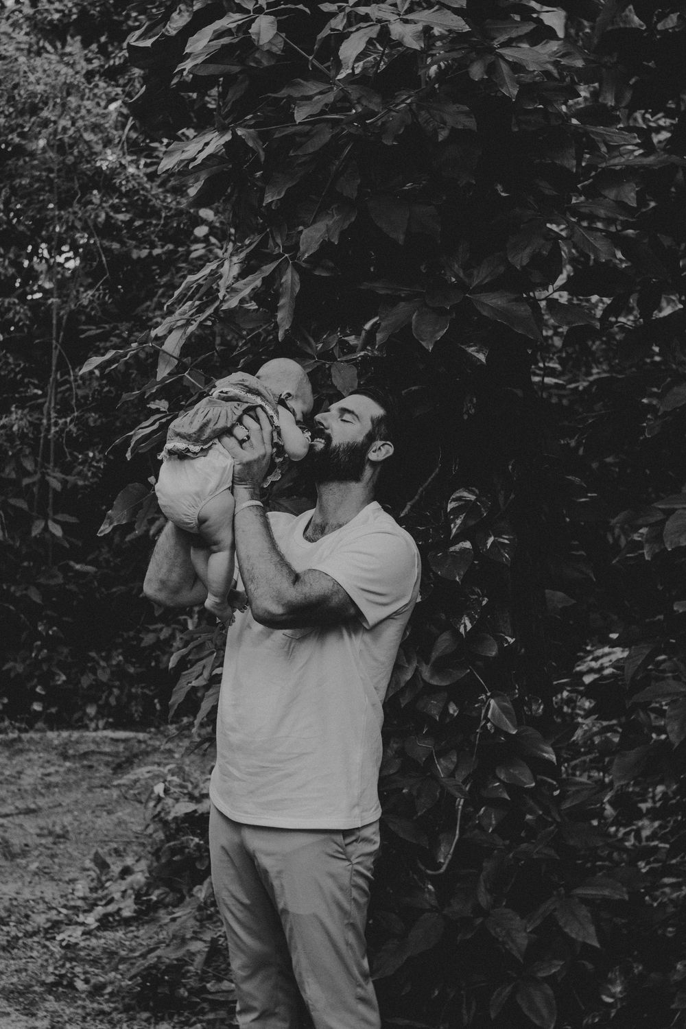 Black and white photo sequence shows someone in a white t-shirt taking a drink from a bottle against a leafy background.