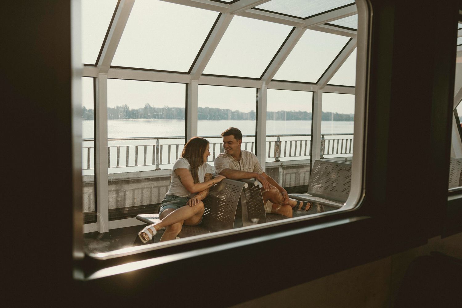 Client photo privacy policy. Couple sits on the Ferry to Wolfe Island. Photographed by Alison, Lumenali Photography, Kingston, Ontario.