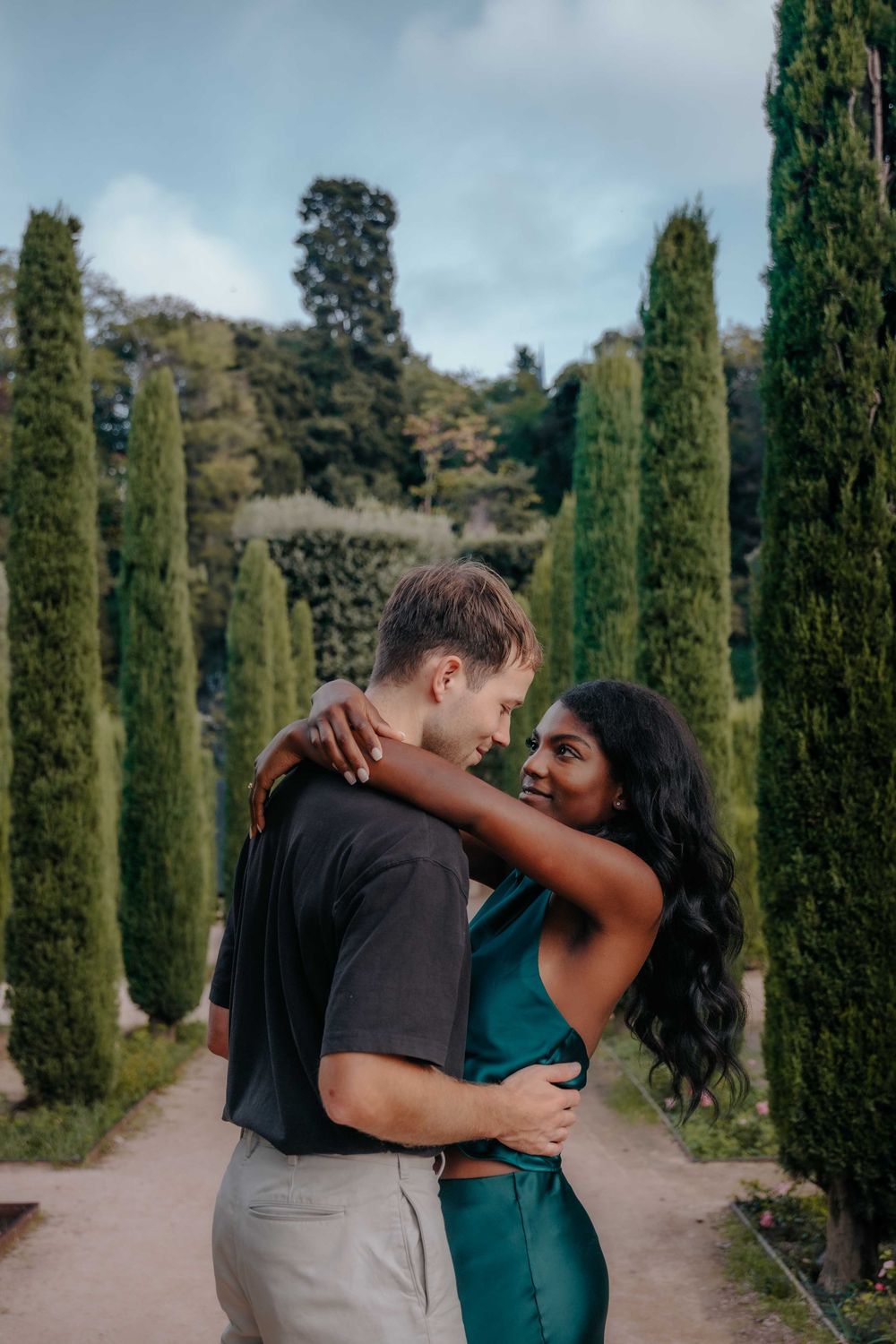 Joyful couple running through the gardens of Teatre Grec Barcelona.