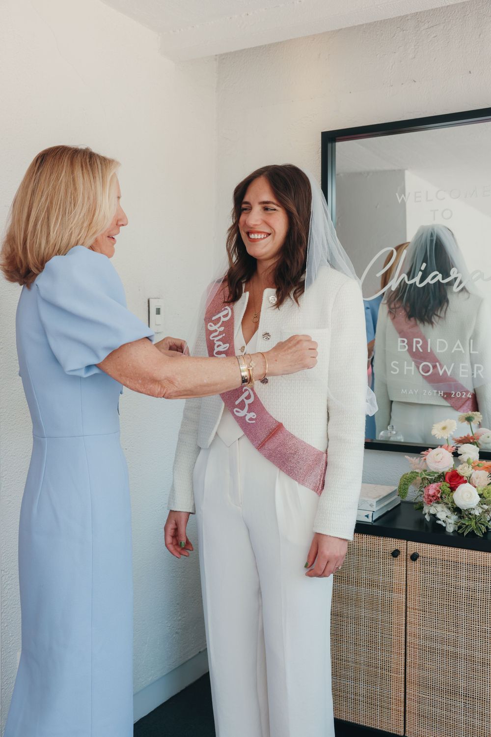 Two women embracing at a bridal shower celebration.