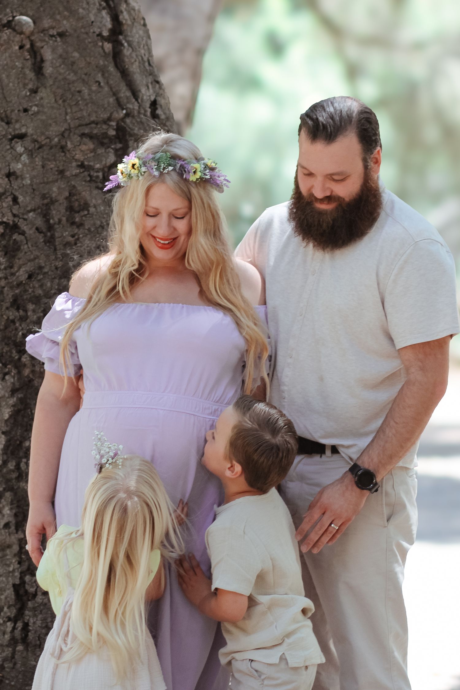 Expecting mother in a flowy dress Miguelito Park Lompoc, CA. Surrounded by trees. Maternity photo shoot.