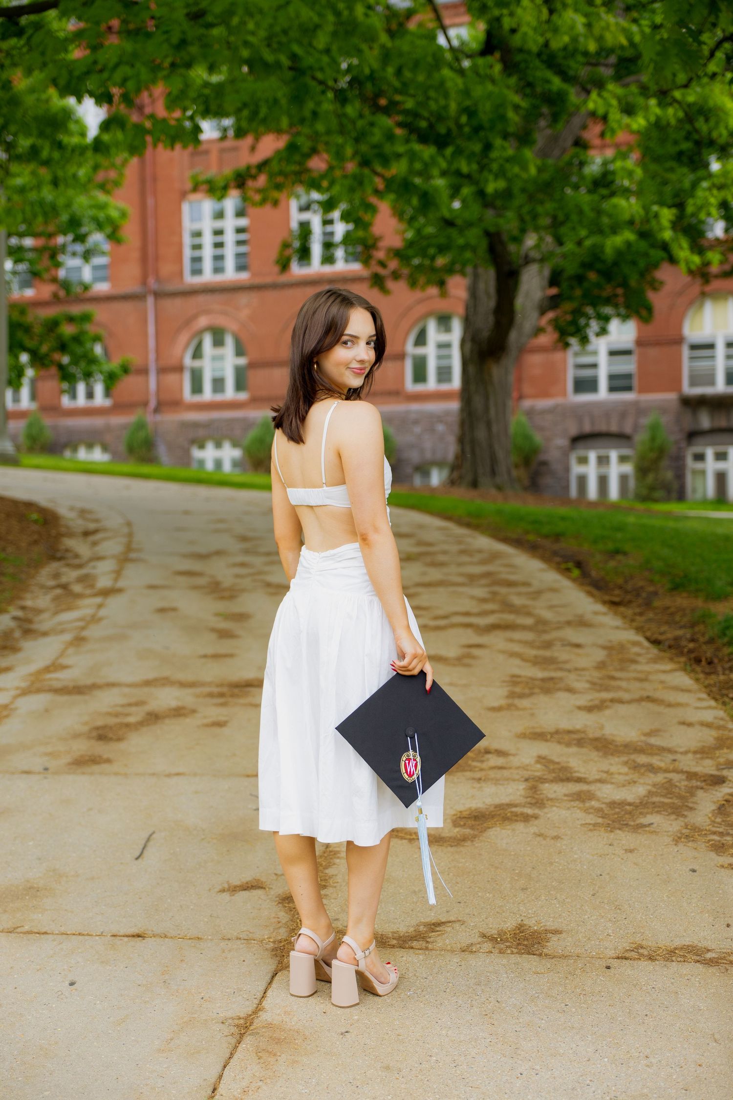A graduate holding her graduation cap