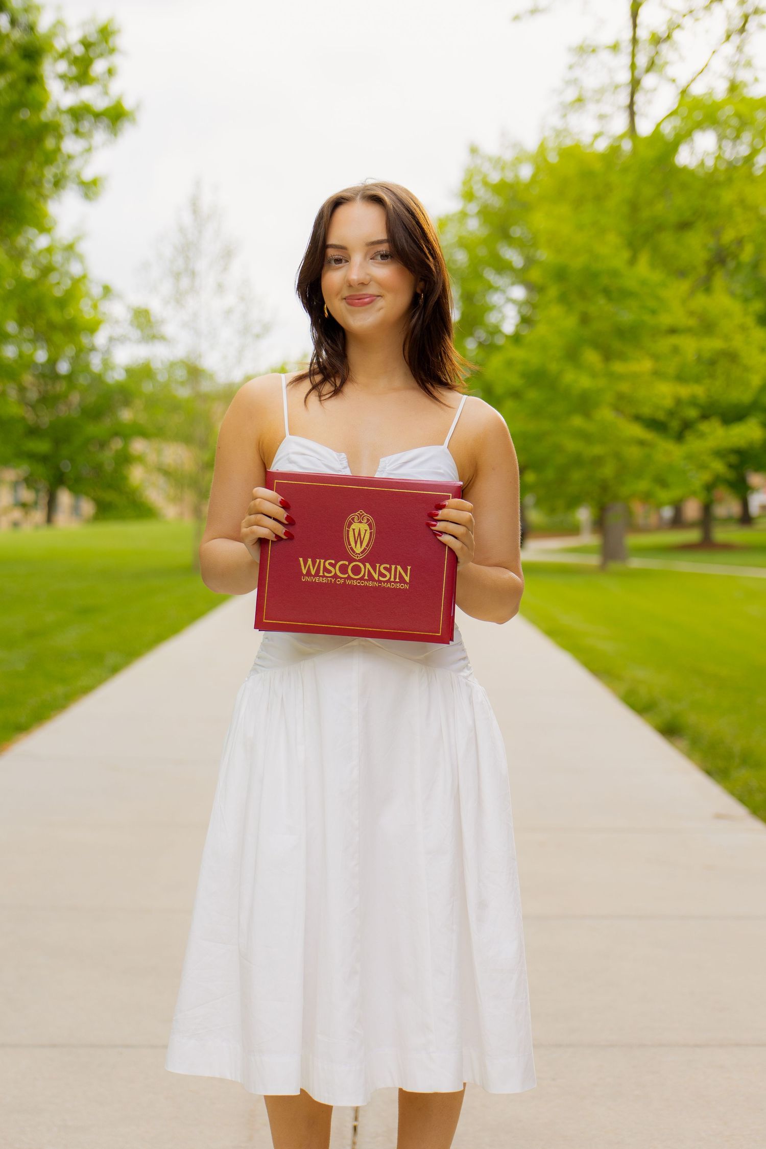 A graduate holding her degree