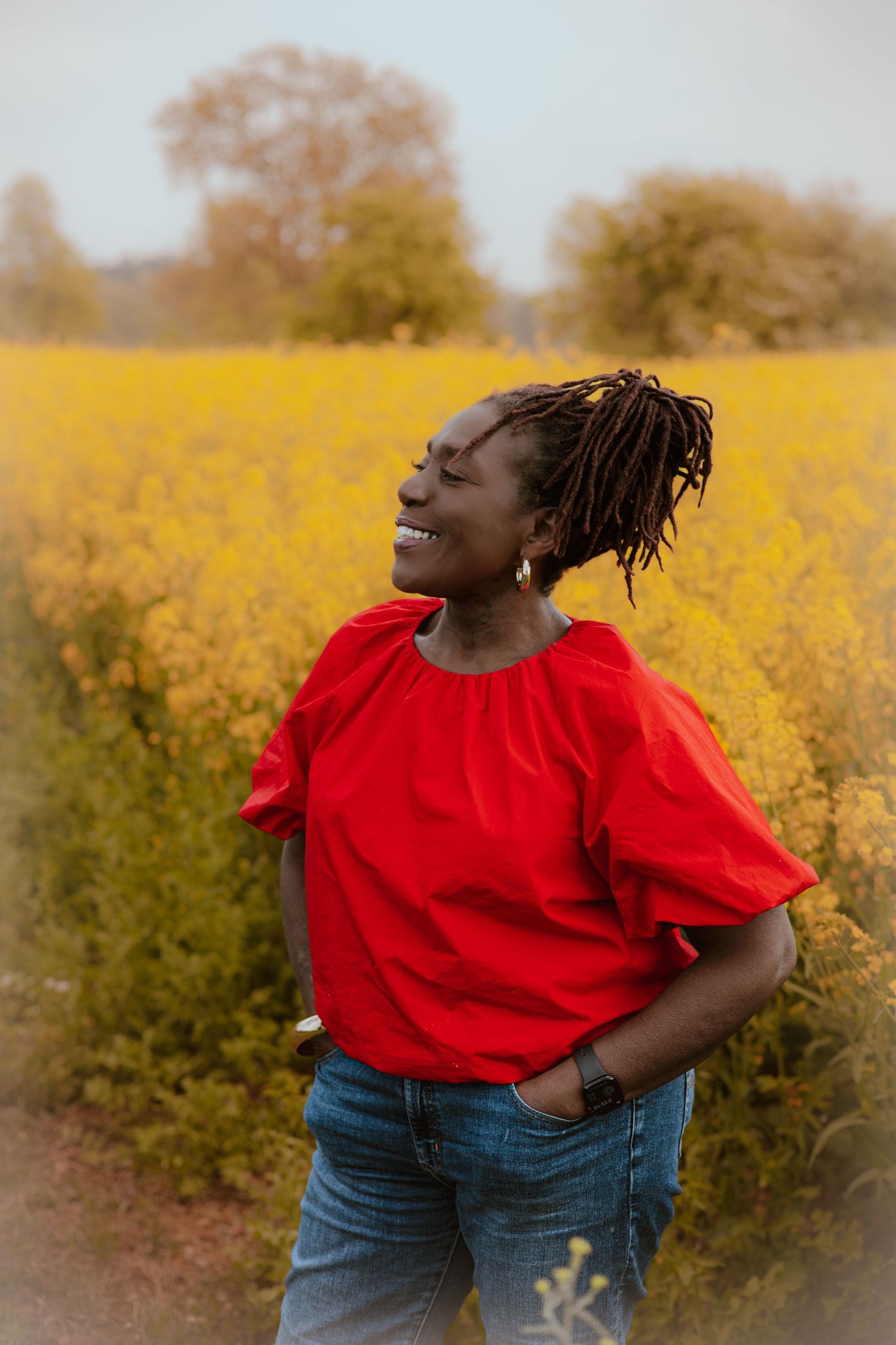 Personal branding, beautiful, black woman. in a flower field, wearing bright bold colours, vibrant ,colourful, Thetford Norfolk