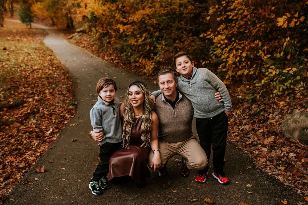 Family with two young boys in fall foliage in Clarksville, Tennessee.