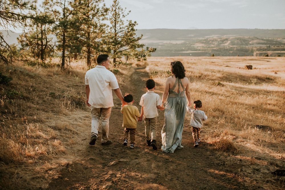 Family walking away from the photographer on a trail in Oregon.