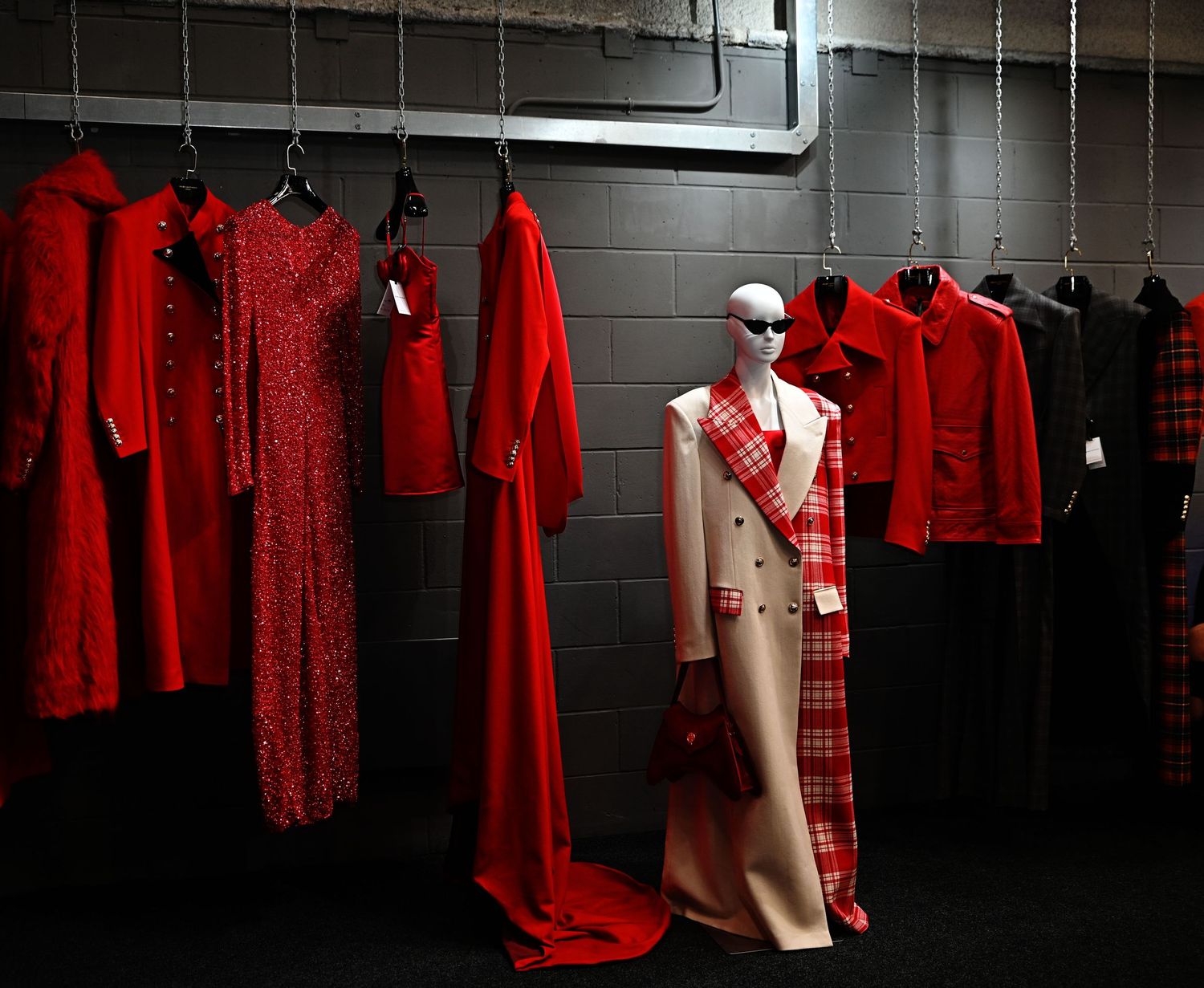 red outfits on a rail, showcases the designers outfits during London Fashion Week.