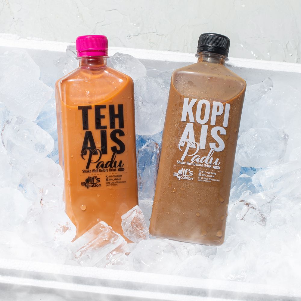 Branded coffee drink bottles arranged in ice with varying shades of brown and orange.