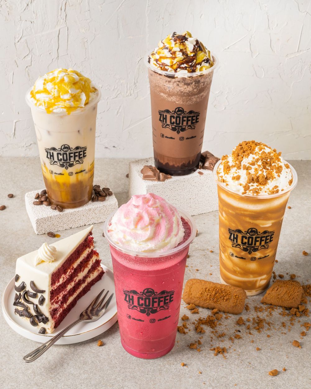 Selection of decorated coffee drinks and desserts with whipped cream and toppings.