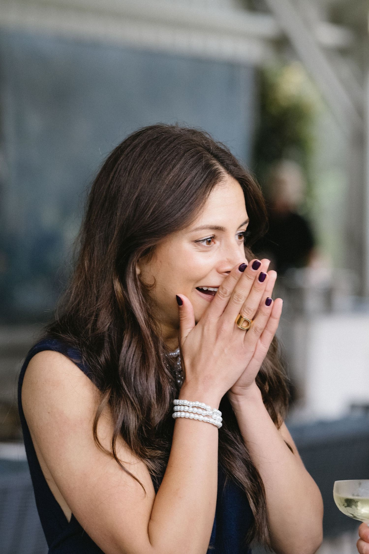 A joyful reaction captured during a wedding reception showing surprised delight.