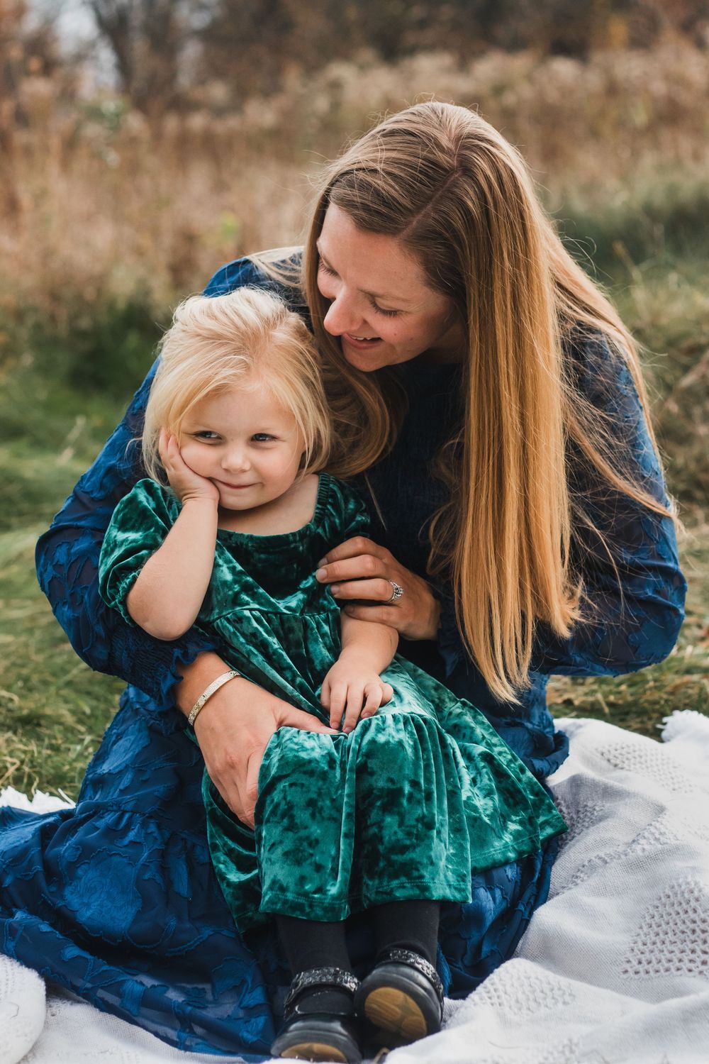 Mother holding daughter during golden hour - lifestyle family photographer in Farmington Hills, Michigan.
