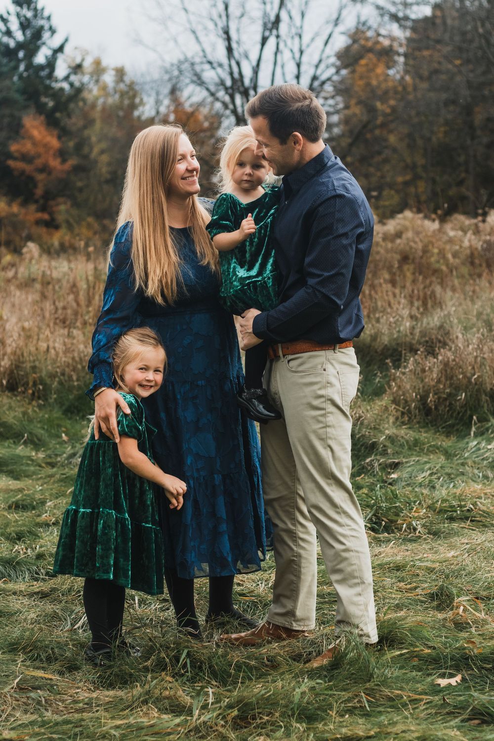 Family smiling for a portrait during a golden hour lifestyle family photography session in Farmington Hills, Michigan.