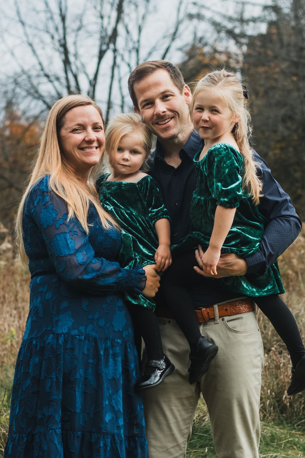 Family smiling for a portrait during a golden hour lifestyle family photography session in Farmington Hills, Michigan.