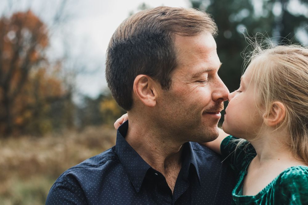 Father and daughter touching noses during a lifestyle family photography session in Farmington Hills, Michigan.
